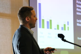John-Erik Pszenny speaking with graph chart 