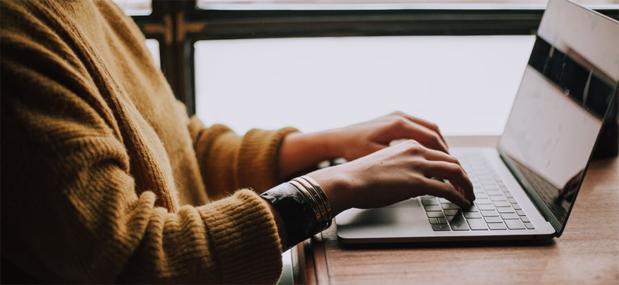 woman typing on a laptop